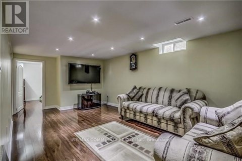 A living room with a couch and a television.