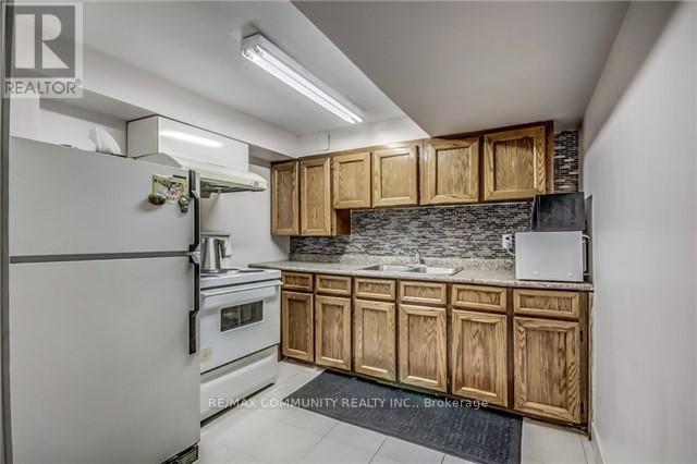 A kitchen with wooden cabinets and a white refrigerator.