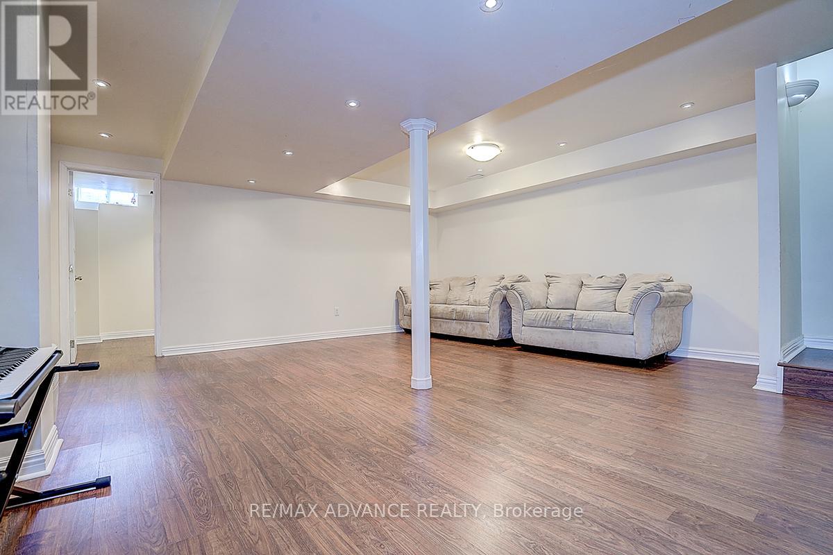 A spacious living room with a couch and a piano.