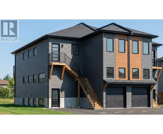 A modern two-story house with a balcony on the second floor.