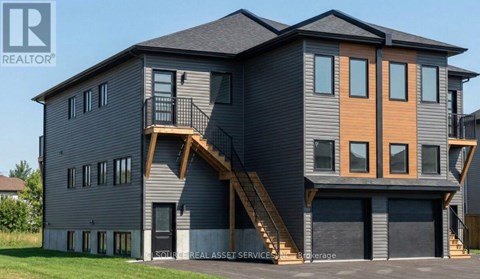 A modern two-story house with a balcony on the second floor.