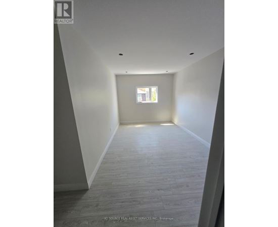 A long hallway with a window at the end.
