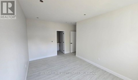 A long hallway with a window at the end.
