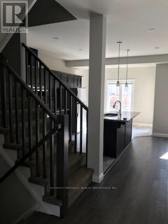 A black metal staircase with a white railing.