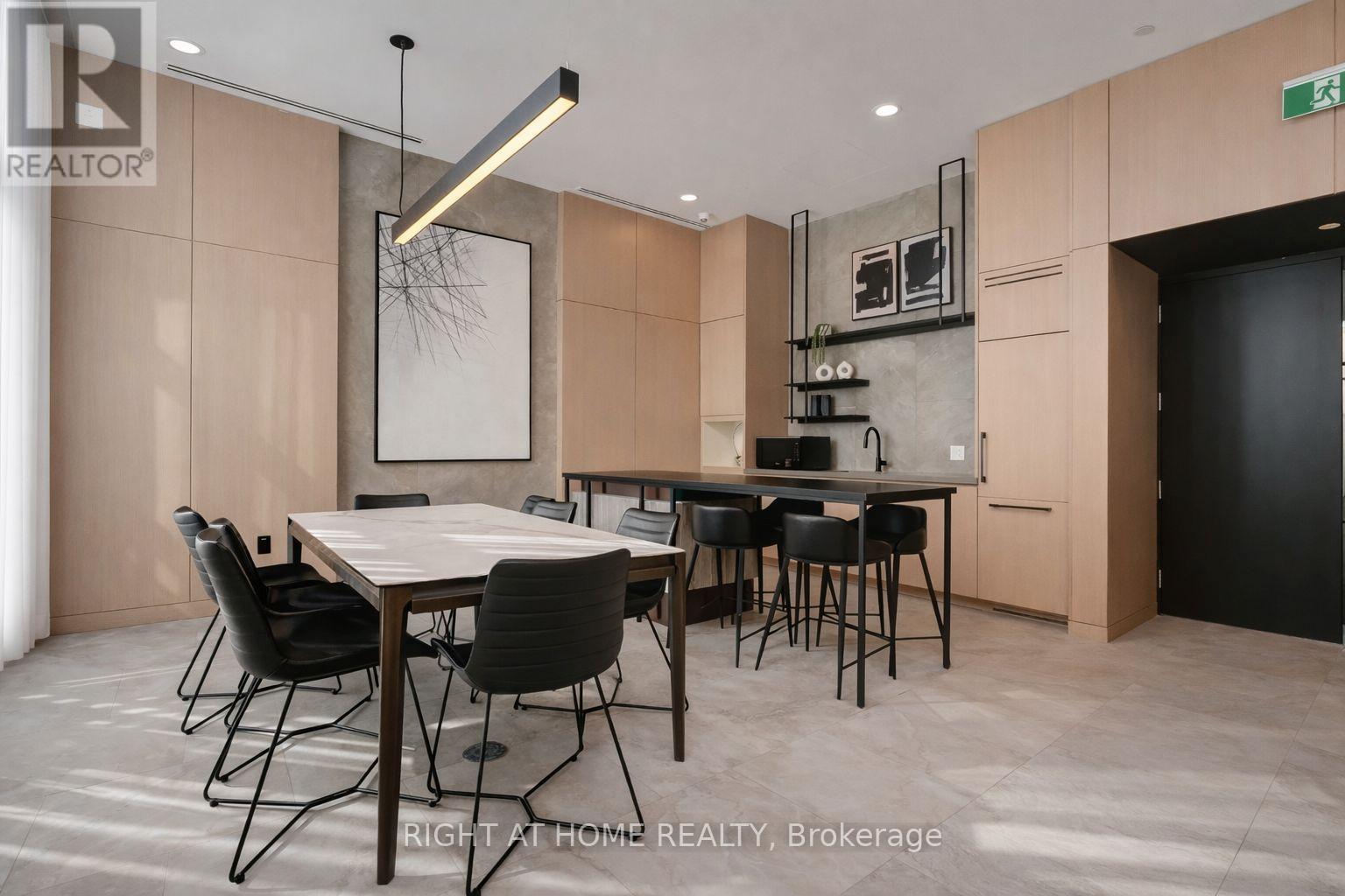 A dining room with a table and chairs.