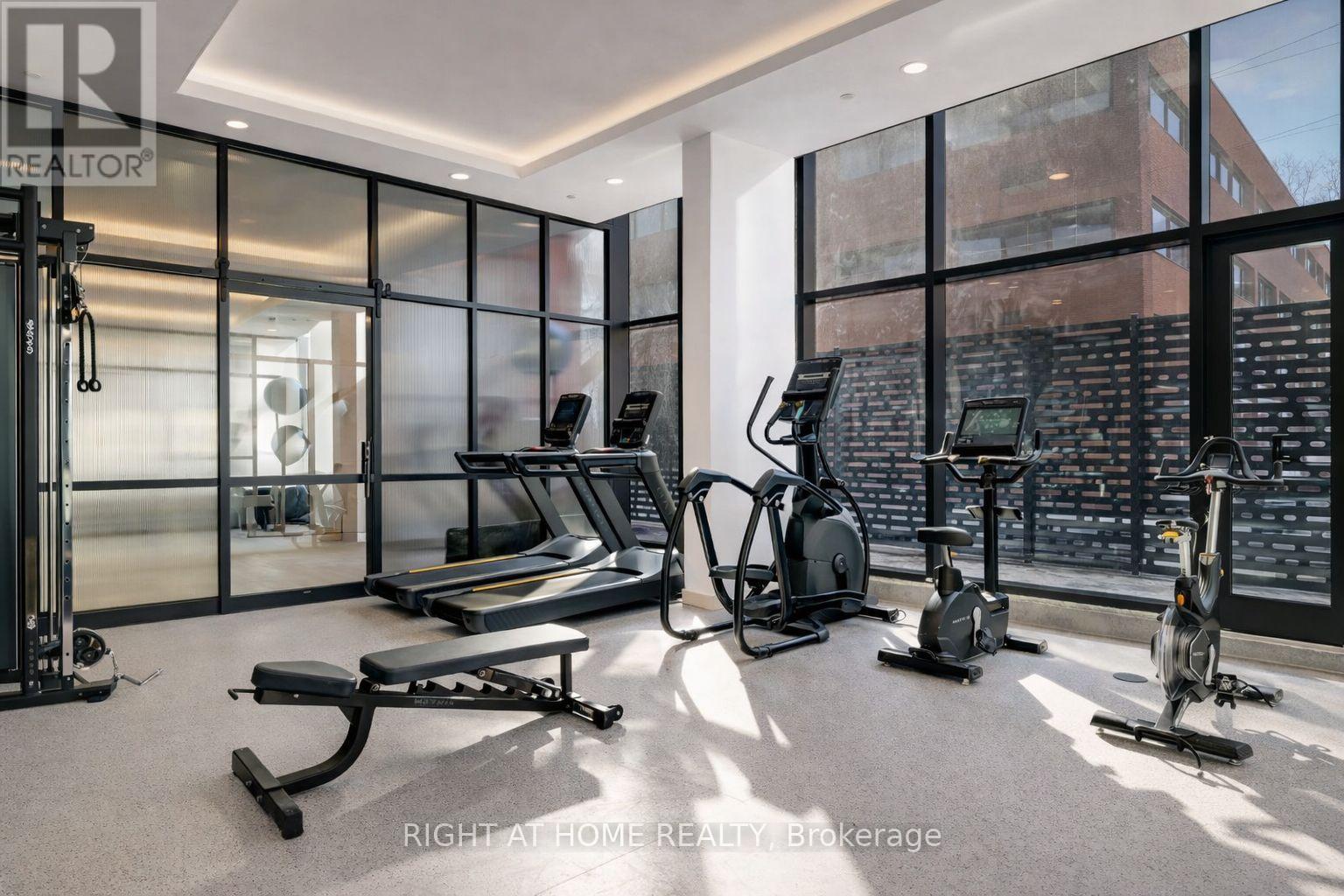 A home gym with a treadmill, elliptical trainer, and stationary bike.