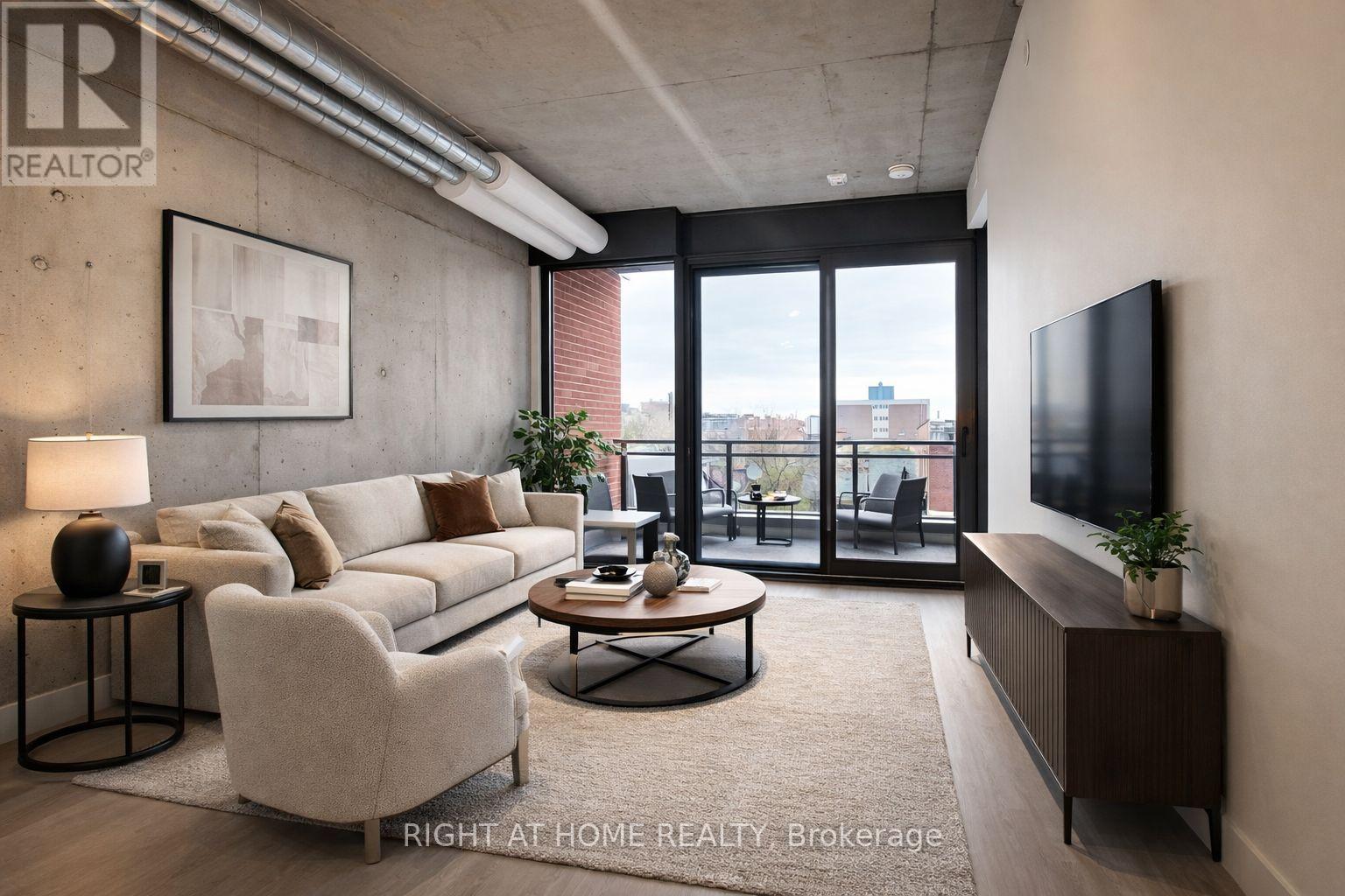 A modern living room with a large window and a flat screen TV.