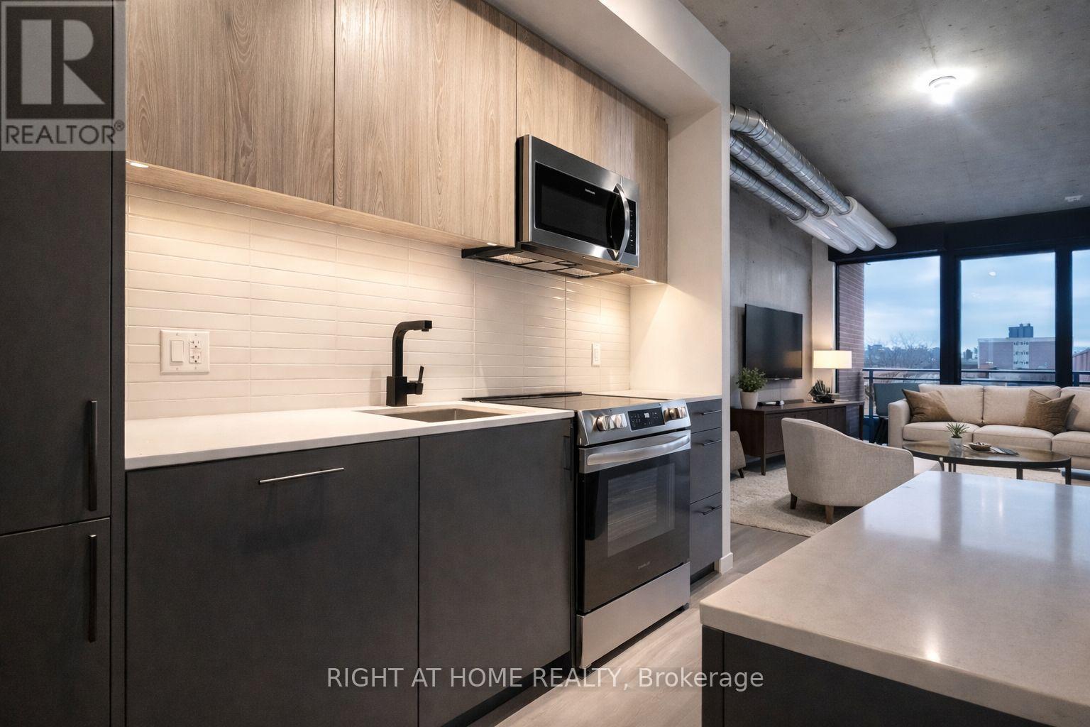 A modern kitchen with a stainless steel oven and microwave above the counter.