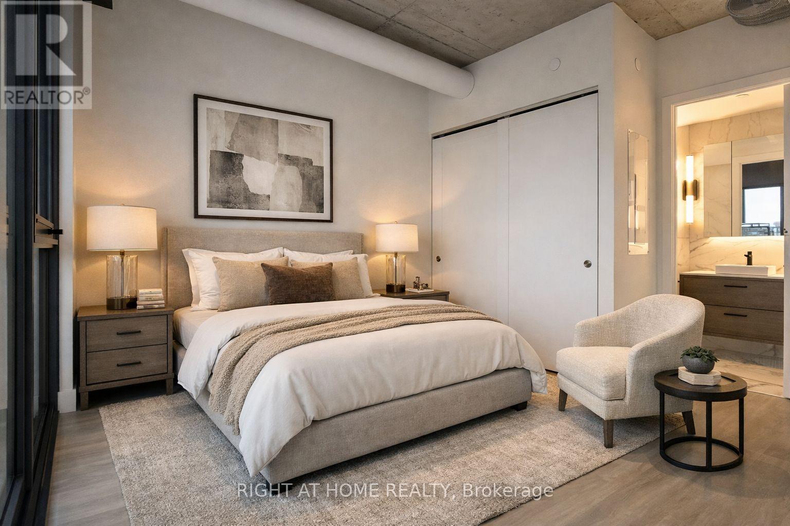 A bedroom with a large bed, a chair, and a painting on the wall.