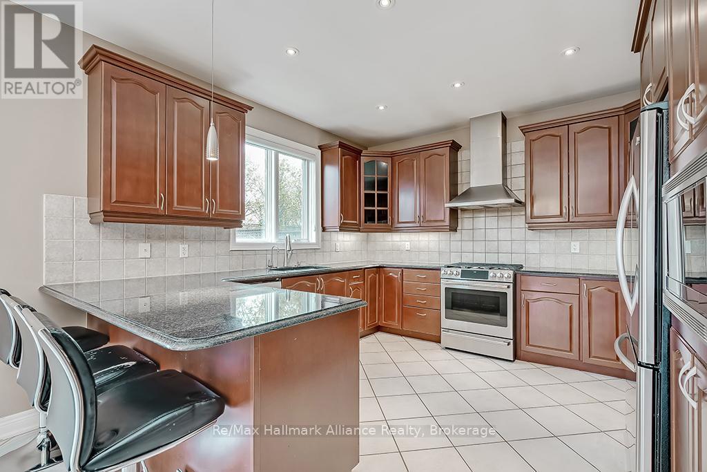 A kitchen with brown cabinets and a granite counter top.