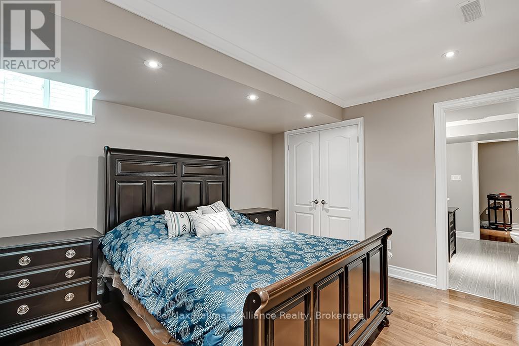 A bedroom with a large bed and a dresser.