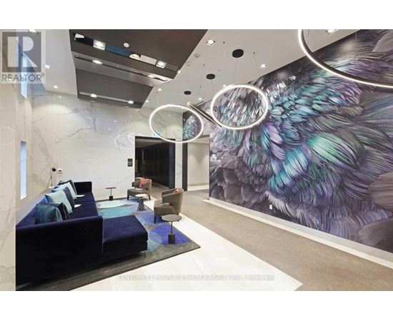 A modern living room with a large mural of a bird on the wall.