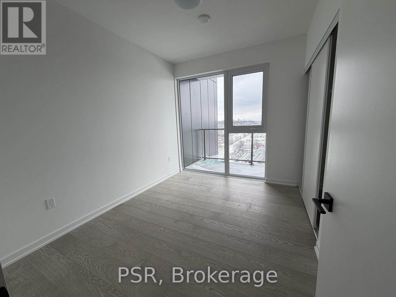A room with a sliding glass door leading to a balcony.