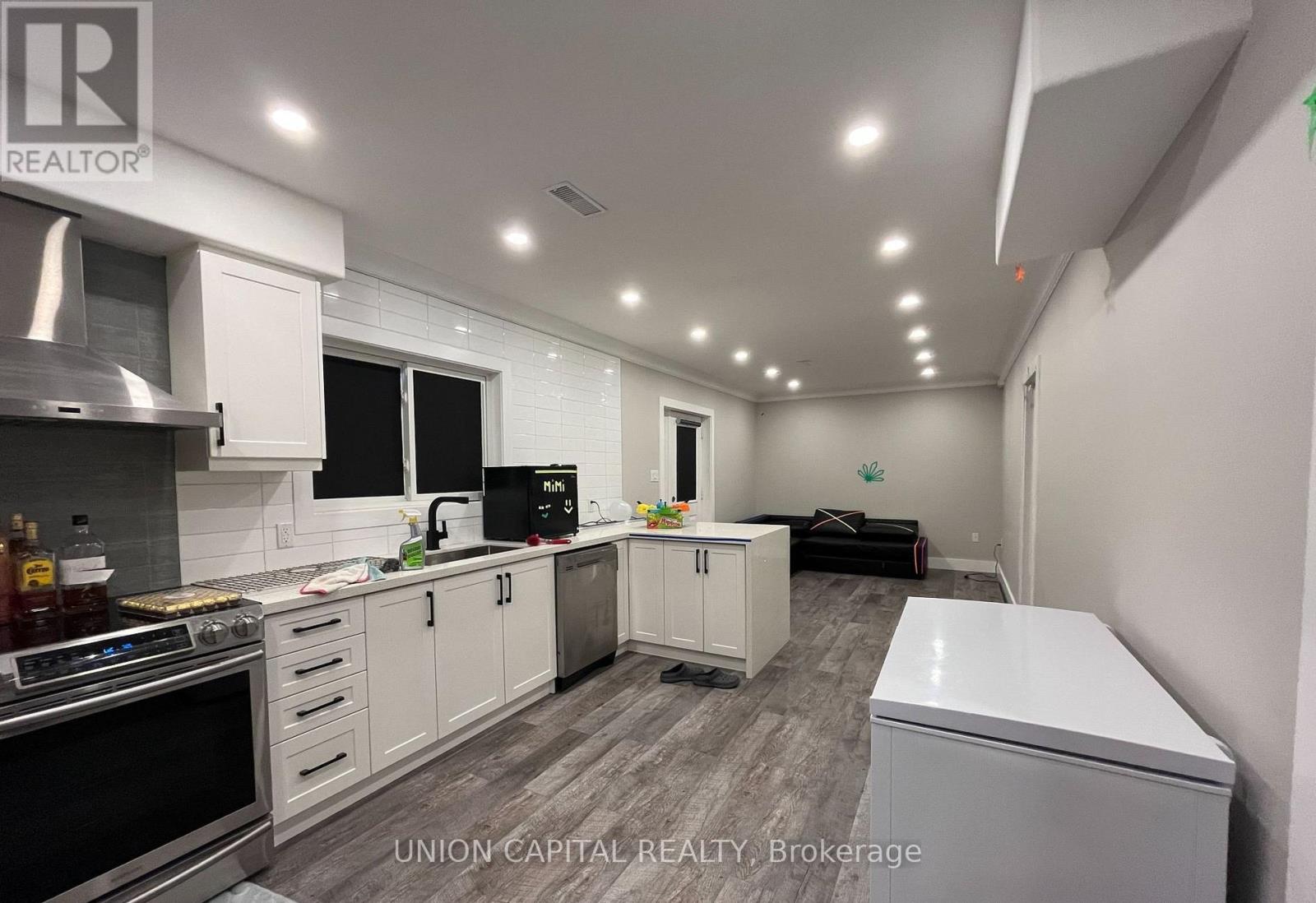 A kitchen with white cabinets and appliances is shown.