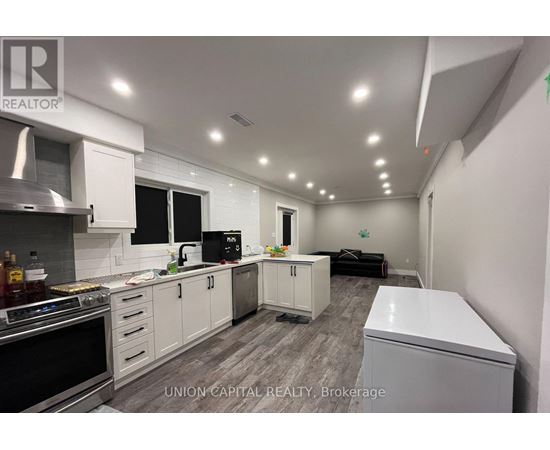 A kitchen with white cabinets and appliances is shown.