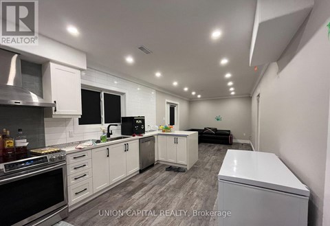 A kitchen with white cabinets and appliances is shown.