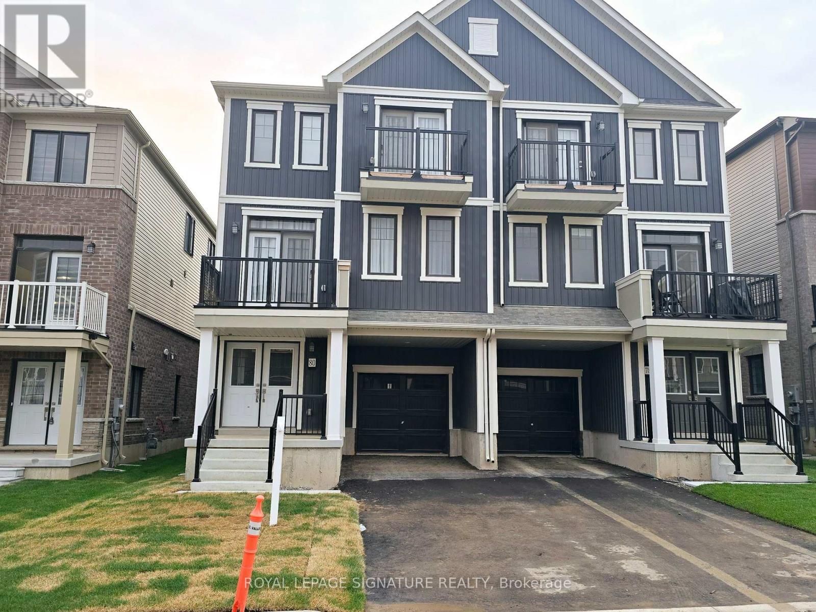 A large two story home with a garage and balcony.