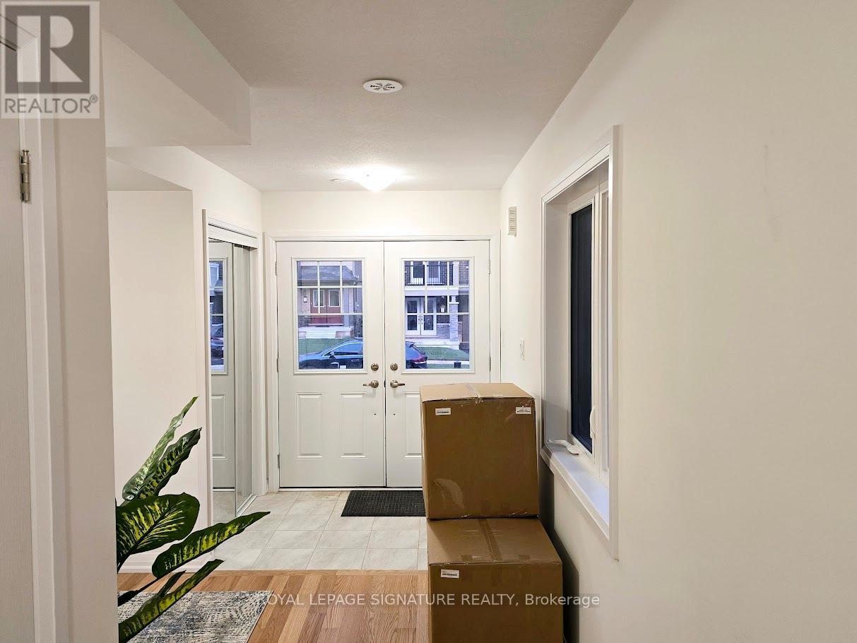 A cardboard box sits on the floor in front of a door.
