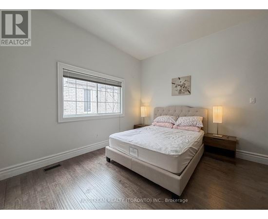 A bedroom with a large bed and a window.