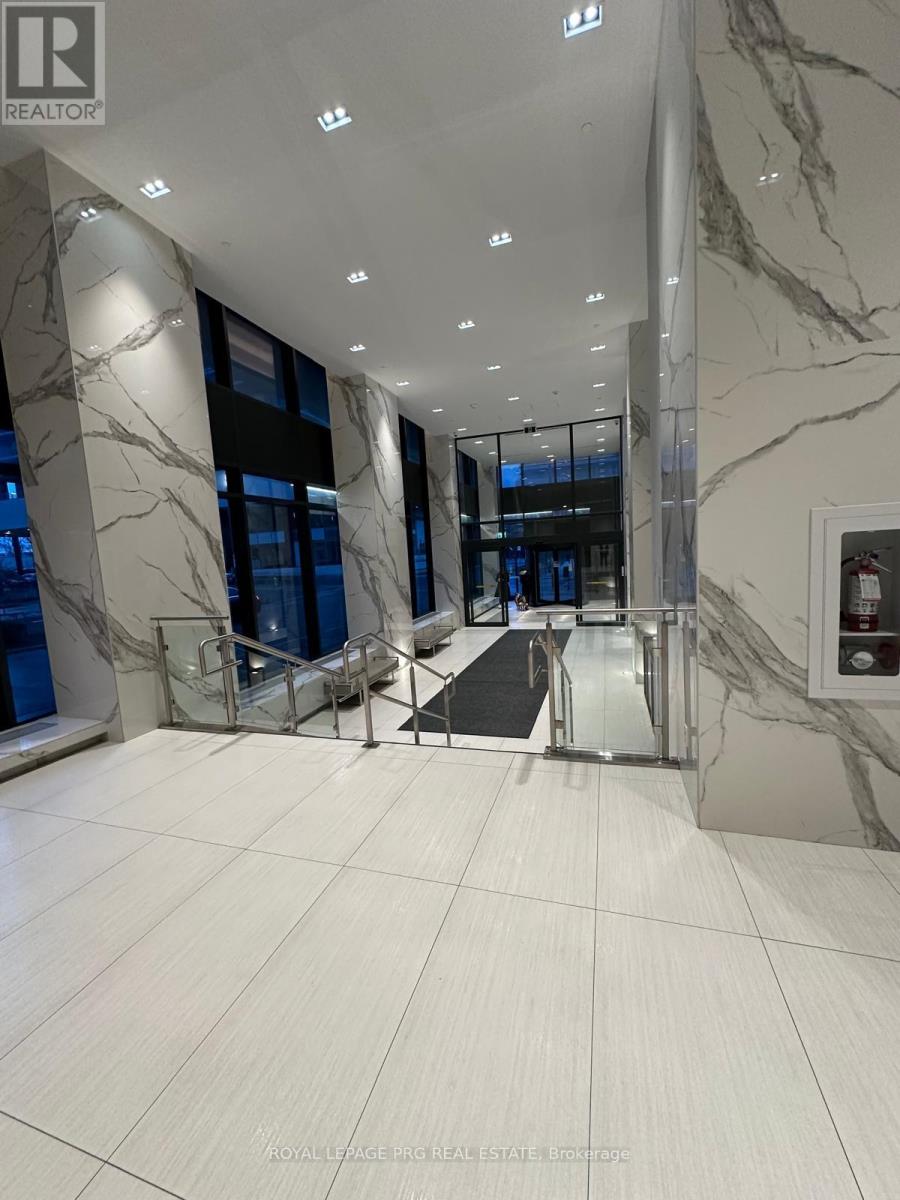 A marble hallway with a glass door at the end.