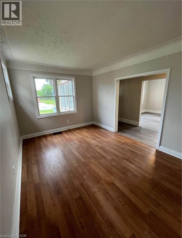 A room with wooden floors and a window.