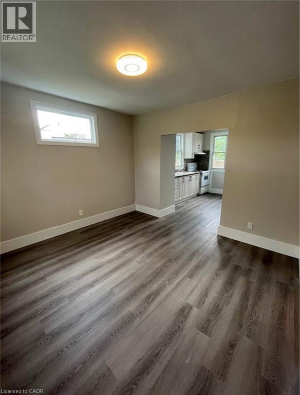 A room with wood flooring and a window.