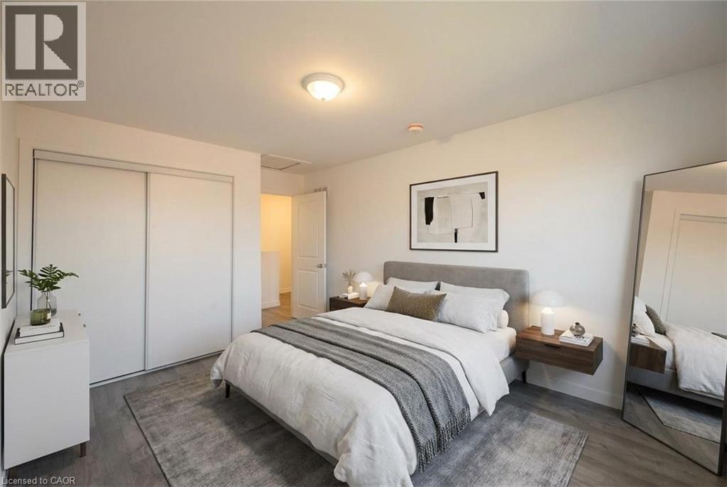 A bedroom with a large bed and a mirror on the wall.