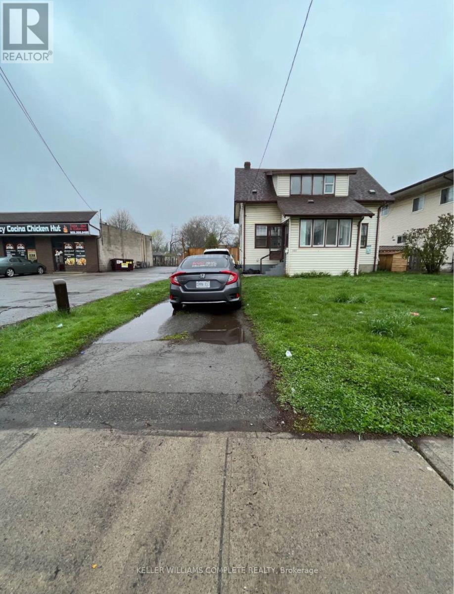 A car is parked on a wet street.