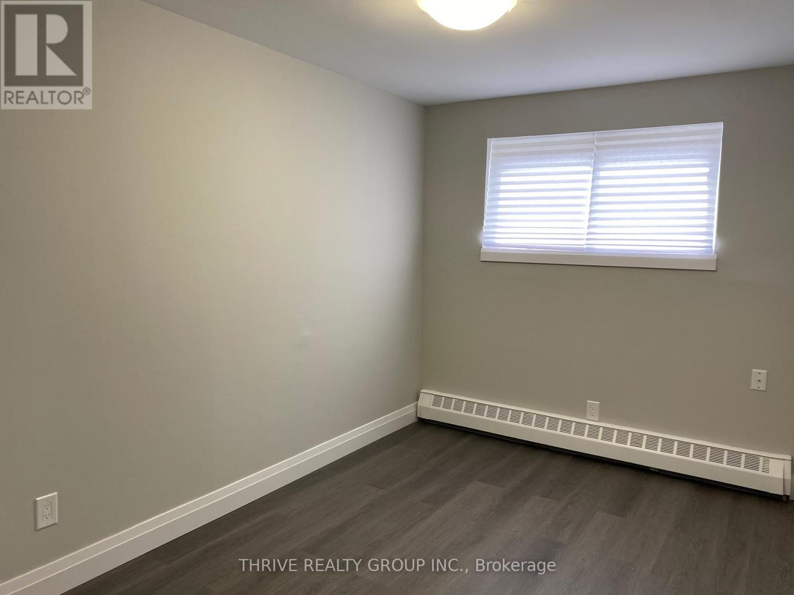 A room with a window and a radiator on the wall.