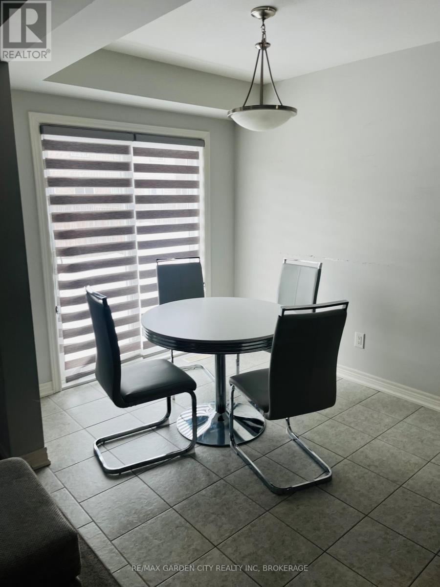 A dining room with a table and chairs.