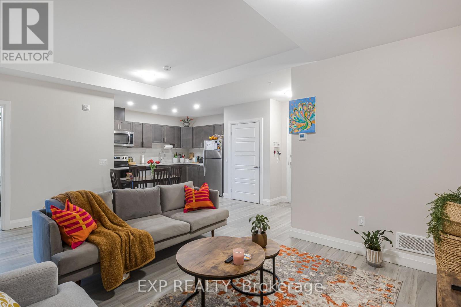 A living room with a grey couch and a coffee table.