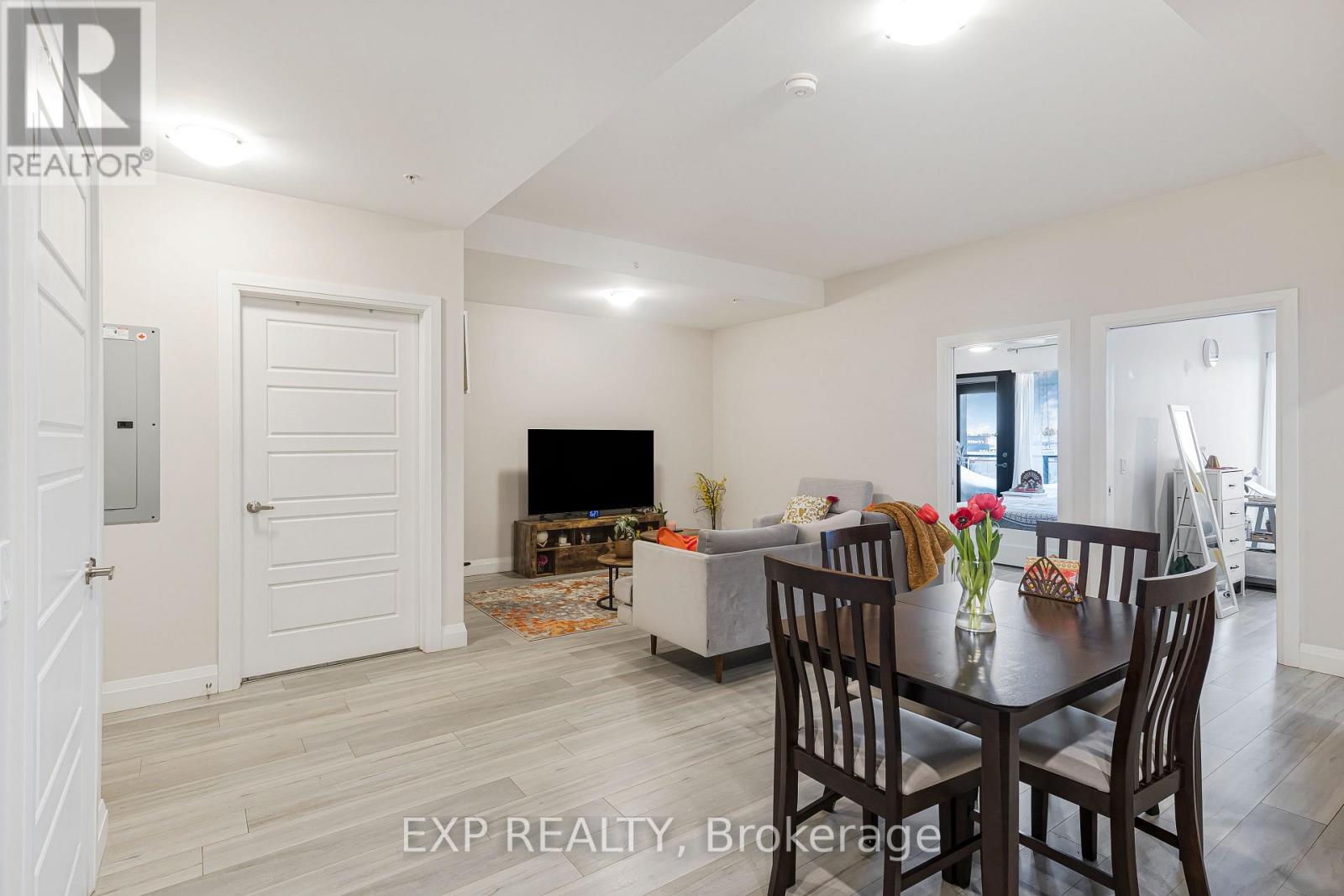 A dining room with a table set for four.