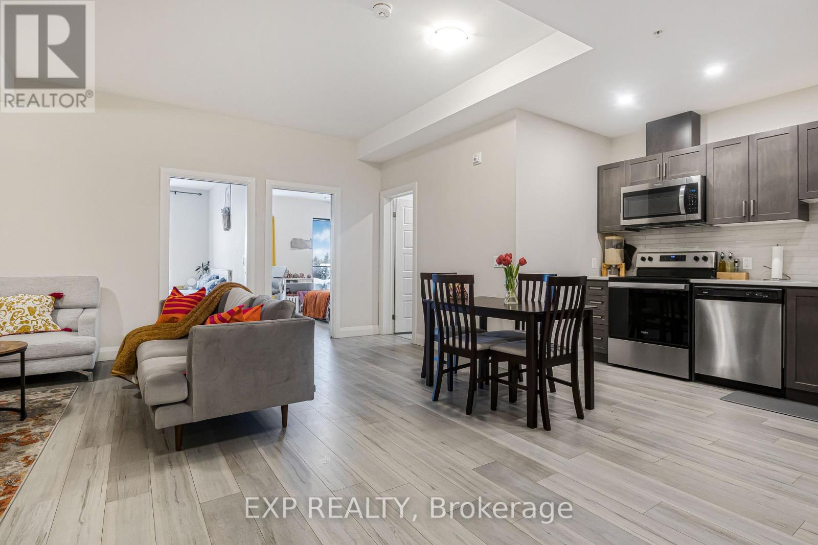 A modern kitchen with a dining table and chairs.