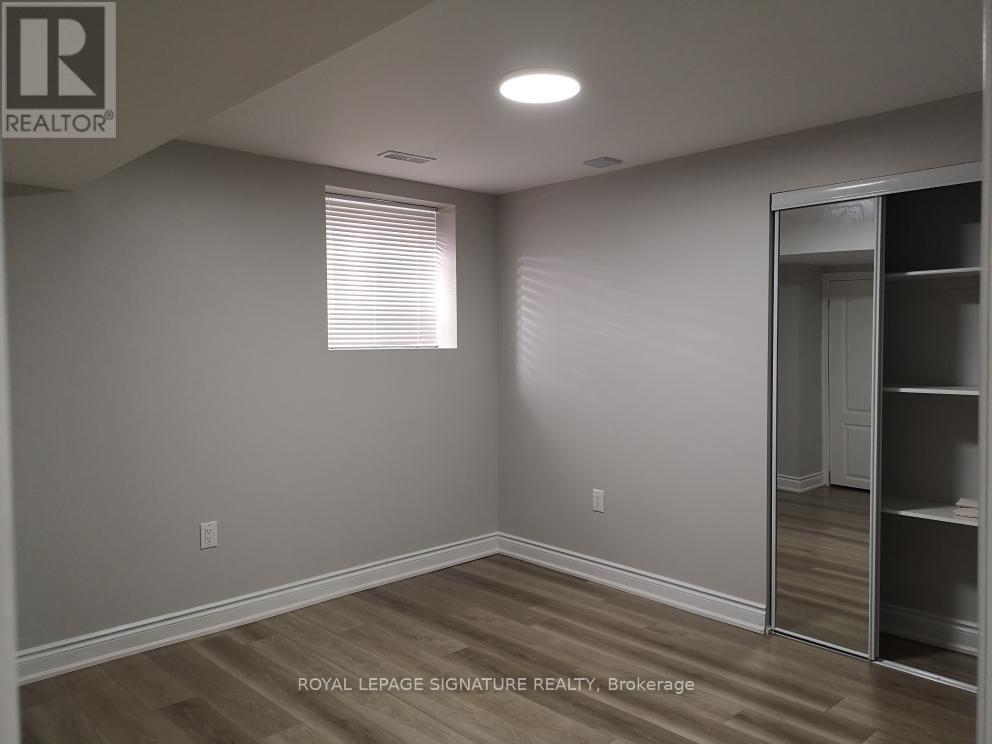 A room with a sliding door and a window with blinds.