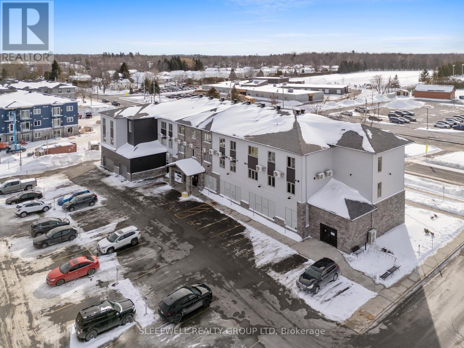 A parking lot with cars and a building in the background.