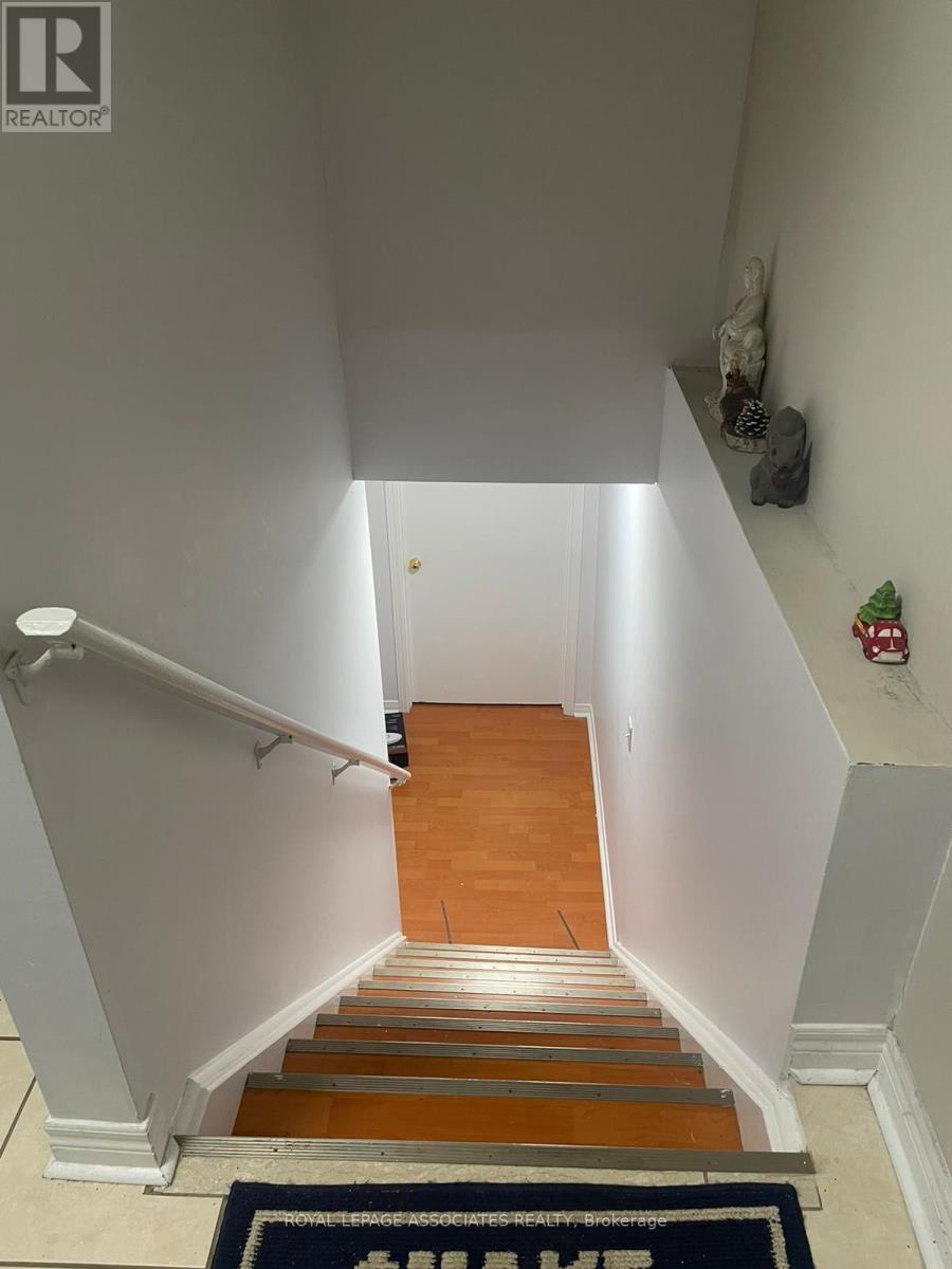 A staircase with a carpet that says "Welcome Home" on it.