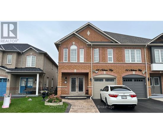 A white car is parked in front of a brick house.