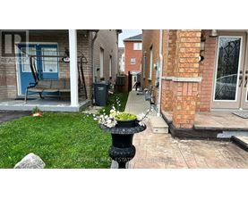 A front yard with a fountain and a blue chair.