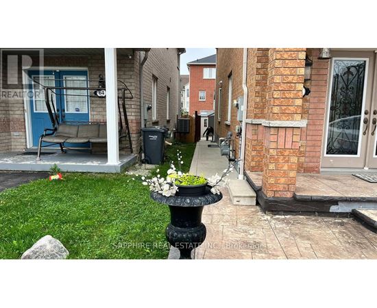 A front yard with a fountain and a blue chair.