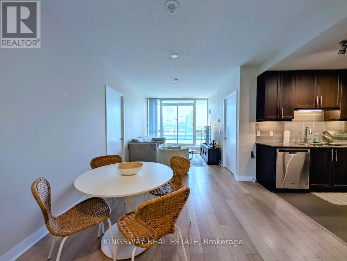 A dining room with a white table and chairs.