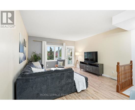 A living room with a grey couch and a television.