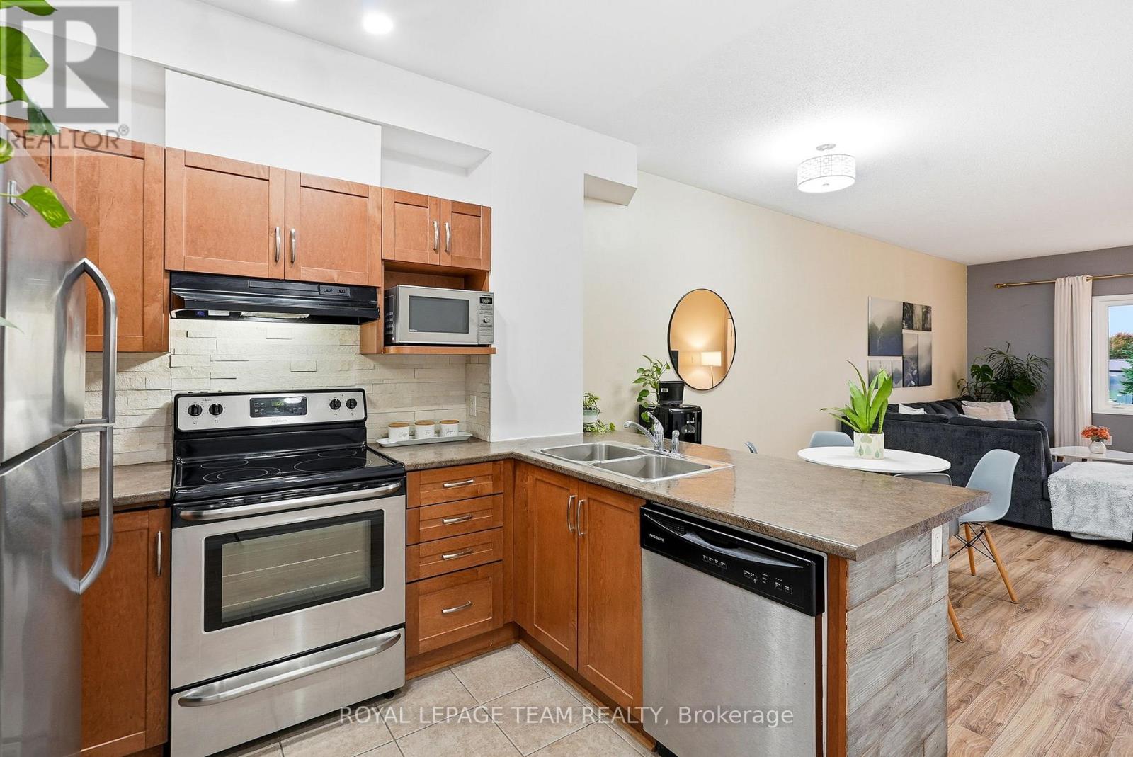 A kitchen with wooden cabinets and stainless steel appliances.