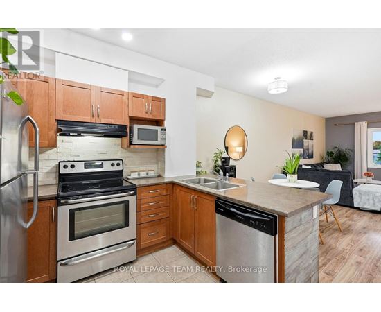 A kitchen with wooden cabinets and stainless steel appliances.