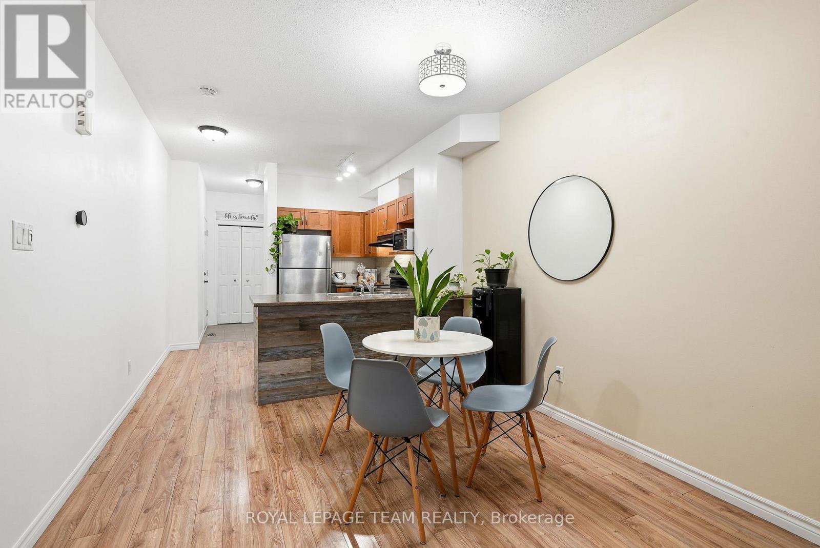 A dining area with a table and chairs in a room with wooden flooring.