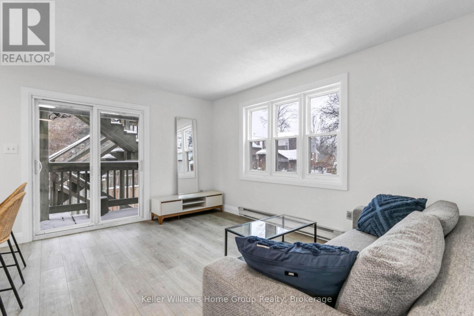 A living room with a couch, a chair, and a coffee table.