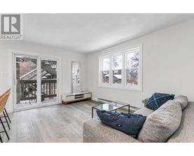 A living room with a couch, a chair, and a coffee table.
