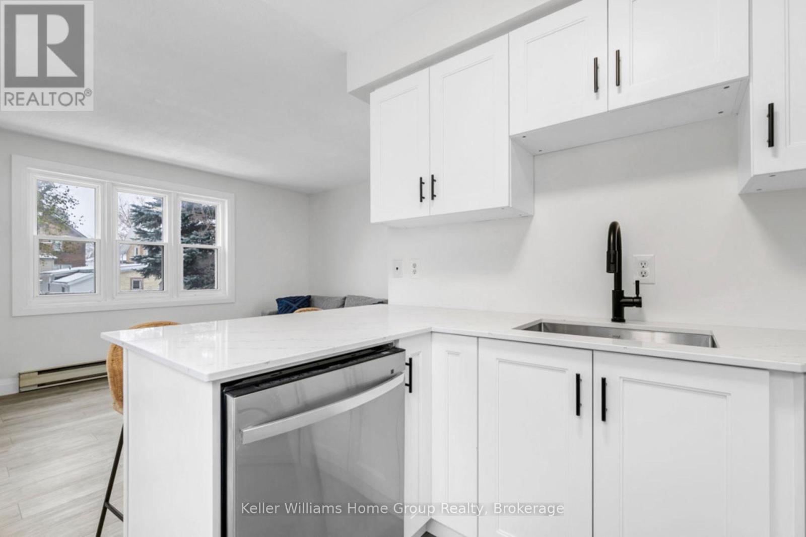 A white kitchen with a sink and cabinets.