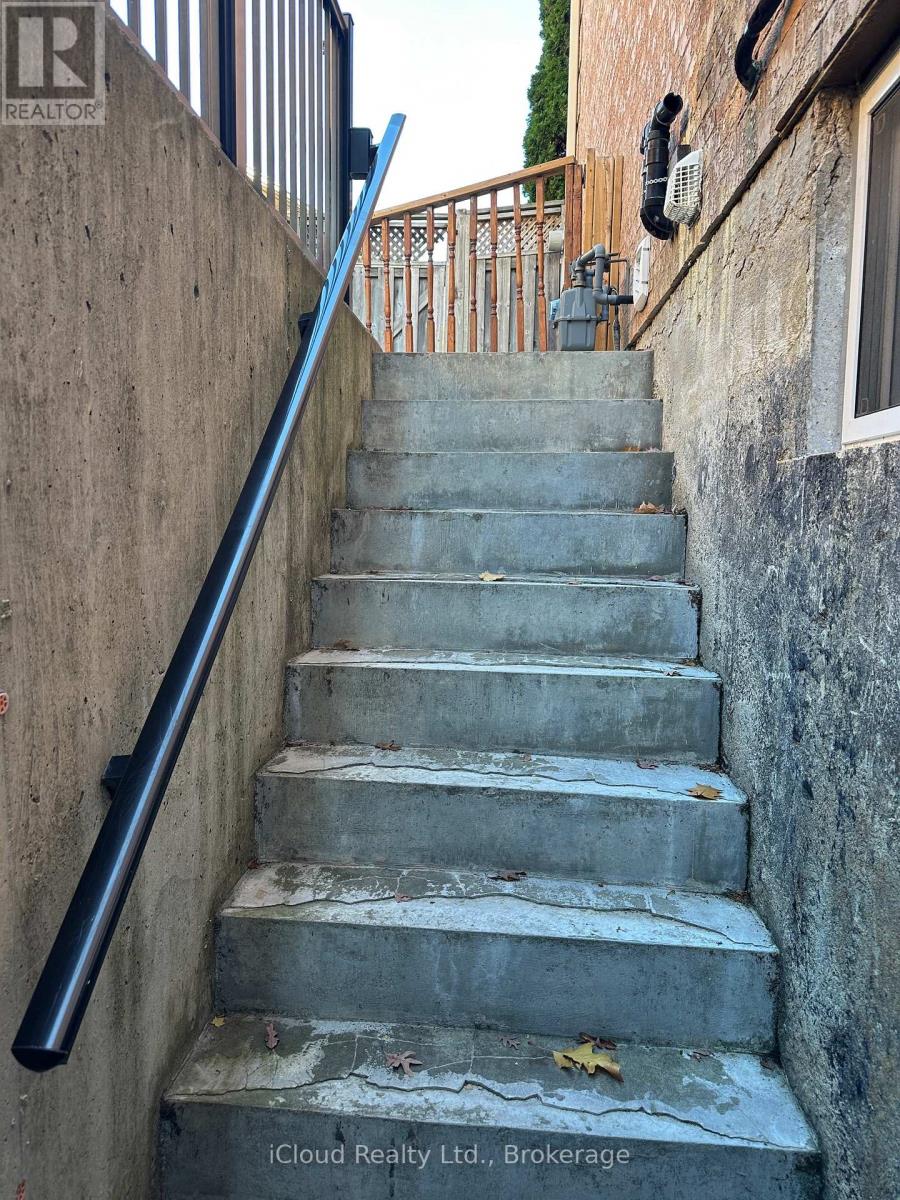 A concrete staircase with a metal handrail.