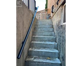 A concrete staircase with a metal handrail.