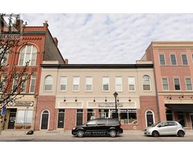 A car is parked in front of a building with a sign that says "Forever Home.".